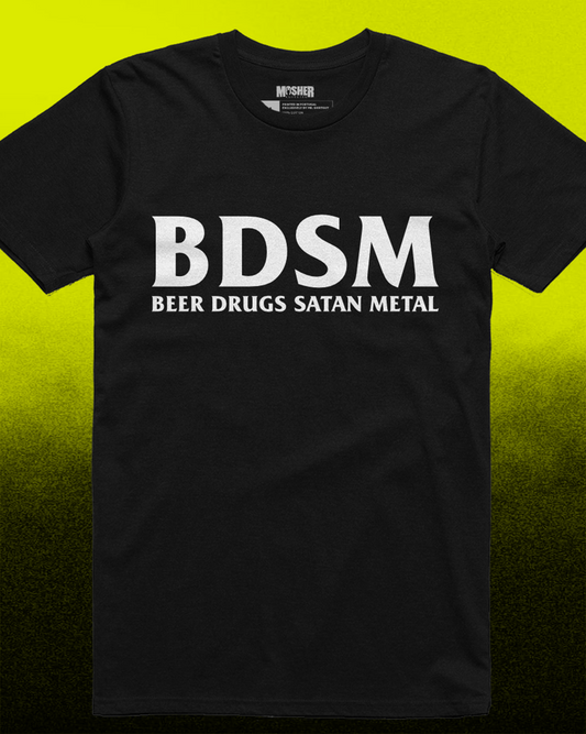 This image features a bold and eye-catching black t-shirt with the phrase "BDSM Beer Drugs Satan Metal" printed in large, white letters on the front. The t-shirt is displayed against a striking red and black background, enhancing its edgy appeal.