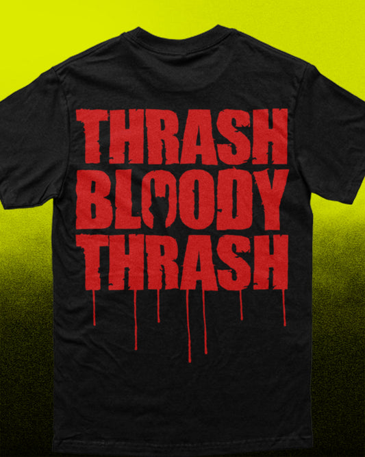 A black short-sleeve t-shirt with a bold red graphic text print reading 'THRASH BLOODY THRASH' in a dripping distressed font, shown against a bright yellow-to-black gradient background.