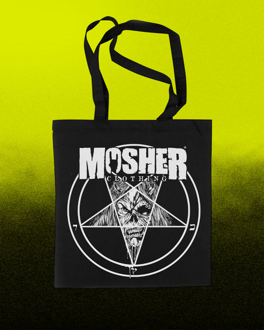 A black canvas tote bag with black handles, featuring a white graphic print of the band Mosher Clothing's skull pentagram logo, set against a bright yellow-to-black gradient background.